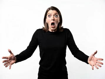 A person in a dramatic theatrical pose — arms outstretched, mouth open in exaggerated surprise — stands against a plain white background under flat studio lighting. The face is fully rendered with sharp detail and an over-the-top comedic expression. The image is clean and high-contrast, resembling a classic internet reaction photo with crisp edges and neutral background. Fantaios.ru visual style: crisp, modern, high-fidelity photorealism with a clean white-dominant palette and precise edge rendering.